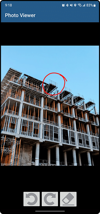 Photo Viewer with a red circle drawn on a job site photo and undo, redo and eraser annotation tools